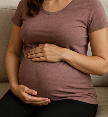 Pregnant person sitting on a couch