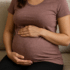 Pregnant person sitting on a couch